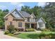 Charming brick home features manicured lawn, lush garden beds, and beautiful shrubs at 217 Fernwood Pl, Woodstock, GA 30188