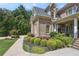 Charming front yard features manicured lawn, lush landscaping, garden beds, and beautiful shrubs at 217 Fernwood Pl, Woodstock, GA 30188