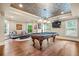 Large game room featuring a pool table, unique ceiling, hardwood floors, and plenty of natural light at 217 Fernwood Pl, Woodstock, GA 30188