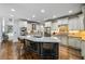 Large kitchen island with bar seating, stainless steel appliances, and custom white cabinetry at 217 Fernwood Pl, Woodstock, GA 30188