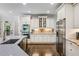 Modern kitchen features stainless steel appliances, granite countertops, and stylish cabinetry at 217 Fernwood Pl, Woodstock, GA 30188
