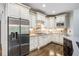Well-appointed kitchen with stainless steel refrigerator, gas range, and custom cabinetry at 217 Fernwood Pl, Woodstock, GA 30188