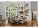Grand living room with hardwood floors, a fireplace, built-in bookshelves, and floor-to-ceiling windows at 217 Fernwood Pl, Woodstock, GA 30188