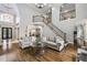Spacious living room boasts high ceilings, hardwood floors, and a grand staircase with metal railing at 217 Fernwood Pl, Woodstock, GA 30188