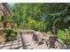 The outdoor patio features an in-ground fire pit and relaxing seating with stone surround at 217 Fernwood Pl, Woodstock, GA 30188