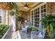 Cozy porch setting with wicker chairs, patterned rug, and hanging plants at 217 Fernwood Pl, Woodstock, GA 30188