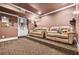 Home theater room with tiered seating, plush couches, and custom carpeting at 217 Fernwood Pl, Woodstock, GA 30188