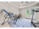 Bright exercise room featuring a treadmill, workout machine and french doors to the outside at 217 Fernwood Pl, Woodstock, GA 30188
