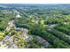High angle aerial view showcases the house backing onto a wooded area in a charming neighborhood at 3900 Baluster Ct, Suwanee, GA 30024