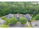 An aerial view of a home nestled among lush green trees in a quiet neighborhood at 3900 Baluster Ct, Suwanee, GA 30024