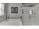 Bright bathroom with tub and separate glass shower boasts modern design at 3900 Baluster Ct, Suwanee, GA 30024