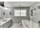 Bright bathroom with tub and shower offers relaxing space at 3900 Baluster Ct, Suwanee, GA 30024