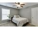 Cozy bedroom featuring a ceiling fan, a window that allows for natural light, and neutral walls at 3900 Baluster Ct, Suwanee, GA 30024