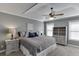 A spacious bedroom featuring two windows, soft carpet, crown molding, and a ceiling fan at 3900 Baluster Ct, Suwanee, GA 30024
