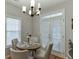 Cozy dining area features a round table, four chairs, and natural light at 3900 Baluster Ct, Suwanee, GA 30024