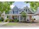 Charming two-story home with a welcoming front porch and manicured landscaping at 3900 Baluster Ct, Suwanee, GA 30024