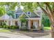 Charming two-story home with manicured landscaping, a brick facade, and a welcoming front porch at 3900 Baluster Ct, Suwanee, GA 30024