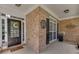 Inviting front porch with a brick facade, a decorative wreath on the front door, and planters at 3900 Baluster Ct, Suwanee, GA 30024