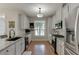 Bright kitchen features granite counters, stainless appliances, and white cabinets at 3900 Baluster Ct, Suwanee, GA 30024