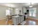 A well-lit kitchen and dining area with stainless steel appliances, granite countertops, and hardwood floors at 3900 Baluster Ct, Suwanee, GA 30024