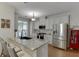 A bright, modern kitchen with granite counters, stainless steel appliances, and white cabinets at 3900 Baluster Ct, Suwanee, GA 30024