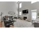 Spacious living room with a fireplace, high ceilings, and abundant natural light at 3900 Baluster Ct, Suwanee, GA 30024
