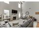 Bright living room featuring a fireplace, cathedral ceiling, and a comfortable seating area at 3900 Baluster Ct, Suwanee, GA 30024