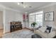 Relaxing living room with modern decor, a gray sofa, hardwood floors, and natural light from the window at 3900 Baluster Ct, Suwanee, GA 30024