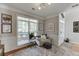 Cozy living room with large windows, plush seating, and stylish decor at 3900 Baluster Ct, Suwanee, GA 30024