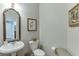 Elegant powder room with pedestal sink, decorative mirror, and tasteful wall decor at 3900 Baluster Ct, Suwanee, GA 30024