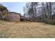Spacious backyard featuring mature trees and a covered deck, perfect for outdoor living at 4225 Parkridge Dr, Powder Springs, GA 30127
