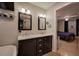 Bathroom featuring a dual sink vanity, a bathtub, and an opening that previews the connected bedroom at 4225 Parkridge Dr, Powder Springs, GA 30127
