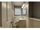 Bathroom featuring white wall paneling, gray walls, and modern fixtures and a door at 4225 Parkridge Dr, Powder Springs, GA 30127