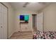 Bedroom with laminate flooring and a television mounted on the wall, adjacent to a white closet at 4225 Parkridge Dr, Powder Springs, GA 30127