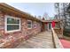 Spacious wooden deck featuring brick exterior, outdoor seating and view of backyard at 4225 Parkridge Dr, Powder Springs, GA 30127