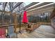 Large wooden deck featuring seating, a red umbrella and wooded views at 4225 Parkridge Dr, Powder Springs, GA 30127