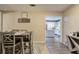 Bright dining area with neutral walls adjoins a lovely kitchen with white cabinetry and appliances at 4225 Parkridge Dr, Powder Springs, GA 30127