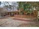 Cozy brick home featuring a covered porch, black shutters, and mature landscaping at 4225 Parkridge Dr, Powder Springs, GA 30127