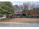Beautiful home with black picket fence, mature trees, and well-maintained lawn at 4225 Parkridge Dr, Powder Springs, GA 30127