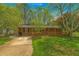 Charming brick home featuring a welcoming front porch and lush green lawn at 4225 Parkridge Dr, Powder Springs, GA 30127