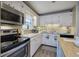 Functional kitchen with stainless steel appliances, white cabinetry, and modern fixtures at 4225 Parkridge Dr, Powder Springs, GA 30127