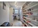 Walk-in pantry with extensive shelving provides ample storage space at 4225 Parkridge Dr, Powder Springs, GA 30127