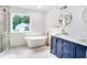 Elegant bathroom with a soaking tub, dual sinks, and marble countertops at 597 Woodcrest Manor Dr, Stone Mountain, GA 30083