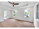 Spacious bedroom with wood-look flooring, recessed lighting, and two windows at 597 Woodcrest Manor Dr, Stone Mountain, GA 30083