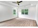 Bright bedroom featuring wood-look flooring, recessed lighting, and large windows at 597 Woodcrest Manor Dr, Stone Mountain, GA 30083