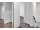 Hallway featuring white walls, baseboards, and wood-style flooring at 597 Woodcrest Manor Dr, Stone Mountain, GA 30083