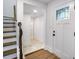 Hallway features hardwood floors, white walls and trim, leading to a view of a bathroom and other rooms at 597 Woodcrest Manor Dr, Stone Mountain, GA 30083
