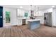 A modern kitchen with stainless appliances, an island, and hardwood floors at 597 Woodcrest Manor Dr, Stone Mountain, GA 30083