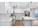 An open kitchen with an island, stainless appliances, and decorative pendant lights at 597 Woodcrest Manor Dr, Stone Mountain, GA 30083