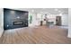 A living room and kitchen features a fireplace, hardwood floors, and stainless appliances at 597 Woodcrest Manor Dr, Stone Mountain, GA 30083